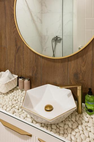 a bathroom with a white sink and a mirror at Panorama GOLD Vrnjačka Banja in Vrnjačka Banja