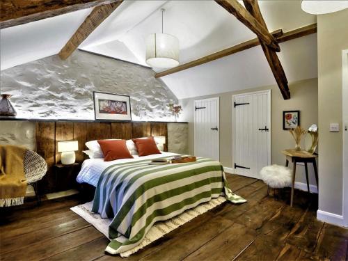 a bedroom with a bed with a green and white blanket at 3 Bed in Tyn Y Groes oc-80476 in Caerhûn