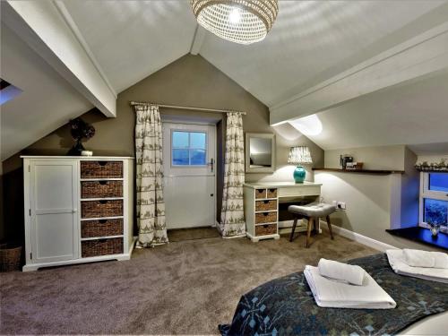 a room with two beds and a desk and a window at 3 Bed in Tyn Y Groes oc-80476 in Caerhûn