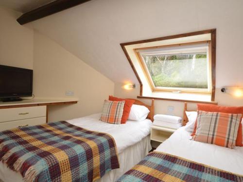a bedroom with two beds and a window at 3 Bed in Conwy oc-typll in Llangelynin