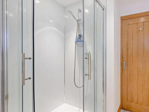 a shower with a glass door in a bathroom at 2 Bed in Arthog oc-43105 in Arthog