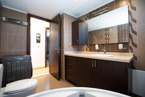 a bathroom with a toilet and a sink at Natural Quiet Accommodation 3 - Faliraki in Kalithies