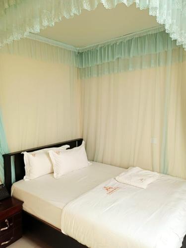 two beds sitting next to each other in a bedroom at SARAB HOTEL Wau in Juba