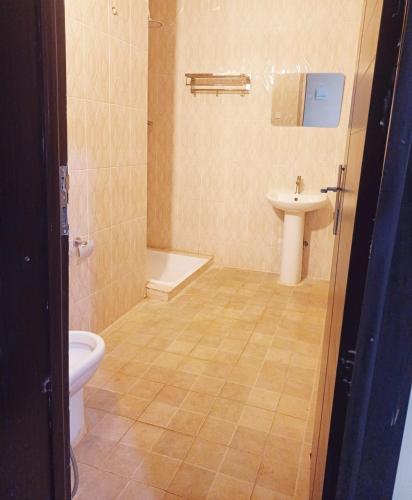 a bathroom with a toilet and a sink at SARAB HOTEL Wau in Juba