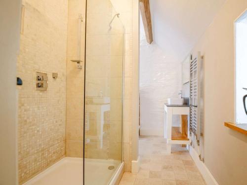 a bathroom with a shower and a bath tub at 1 Bed in Corwen oc-52509 in Corwen