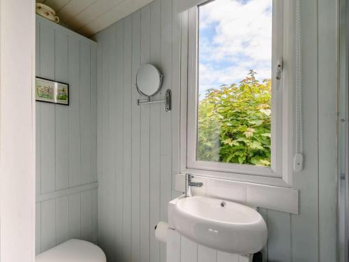 a bathroom with a sink and a mirror and a window at 1 Bed in Kilgetty oc-88421 in Jeffreston