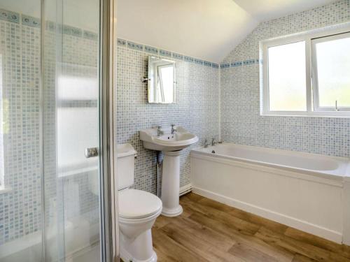 a bathroom with a toilet and a sink and a tub at 2 Bed in Swansea oc-62019 in Reynoldston