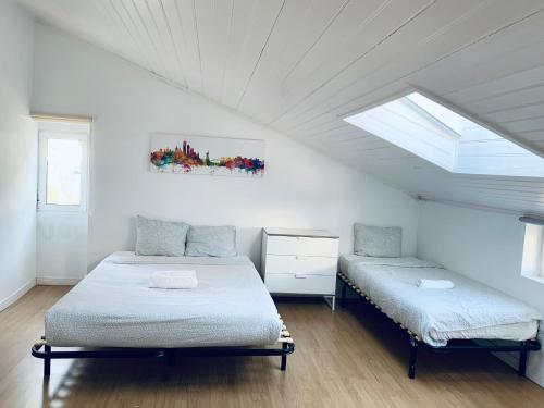 a bedroom with two beds in a attic at Gama House Shared Appartment in Lisbon