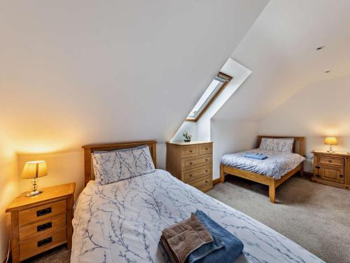 a bedroom with a bed and a desk and a chair at 3 Bed in Arthog oc-77304 in Arthog