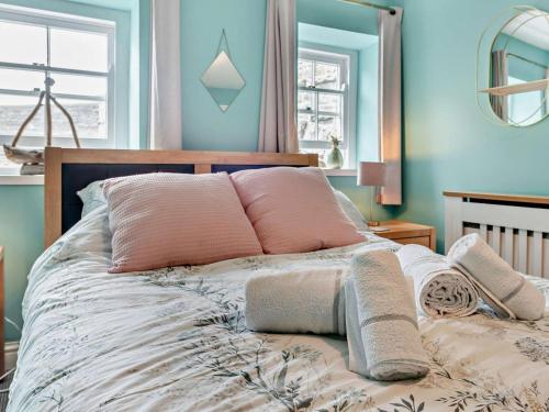 a bedroom with a bed with blue walls at 1 Bed in Aberaeron oc-49261 in Aberaeron