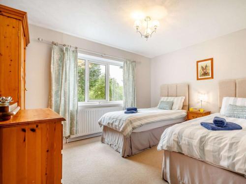 a bedroom with two beds and a window at 3 Bed in Bala oc-88351 in Frongoch
