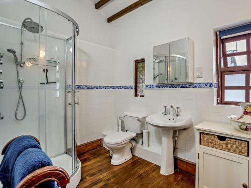 a bathroom with a toilet sink and a shower at 1 Bed in Swansea oc-77980 in Penclawdd