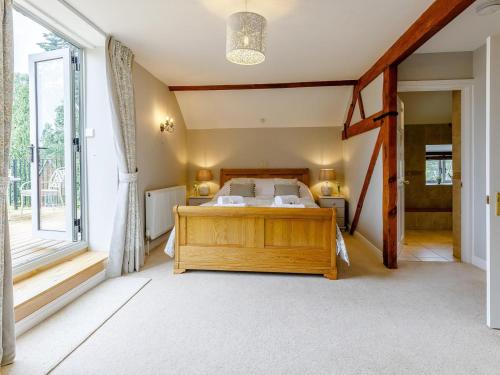 a bedroom with a bed and a large window at 3 Bed in Presteigne oc-78350 in Kinsham