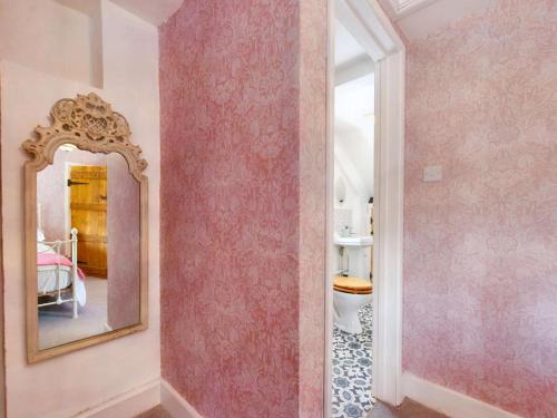 a bathroom with a mirror and a pink wall at 2 Bed in Swansea oc-88216 in Port-Eynon