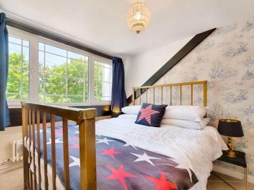 a bedroom with a wooden bed with stars on it at 2 Bed in Swansea oc-88216 in Port-Eynon