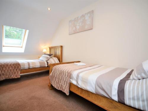 a bedroom with two beds and a window at 3 Bed in Narberth oc-36798 in Llawhaden