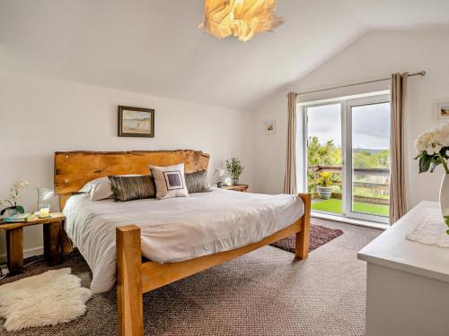 a bedroom with a large bed and a large window at 2 Bed in Swansea oc-78845 in Ilston