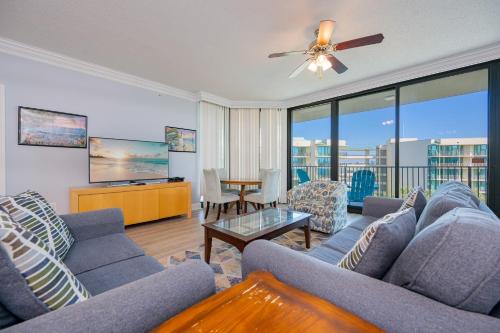 a living room with a couch and a table at Phoenix on the Bay 1409 condo in Orange Beach