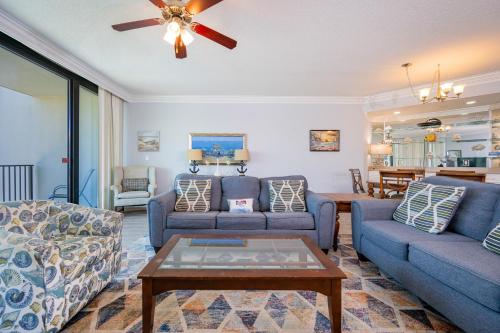 a living room with two couches and a table at Phoenix on the Bay 1409 condo in Orange Beach
