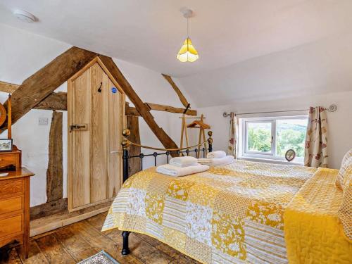 a bedroom with a bed and a window at 2 Bed in Craven Arms oc-83166 in Clun