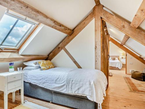a bedroom with a bed and a window at 4 Bed in Amlwch oc-90258 in Llanfechell