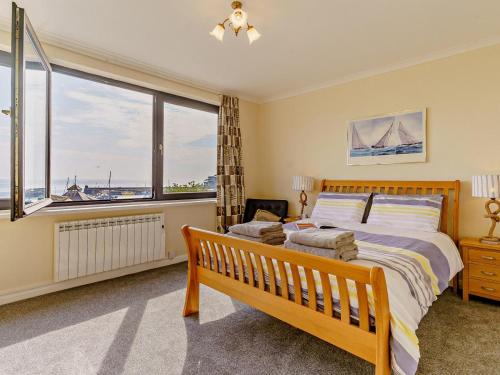 a bedroom with a bed and a large window at 2 Bed in Saundersfoot oc-74356 in Saundersfoot