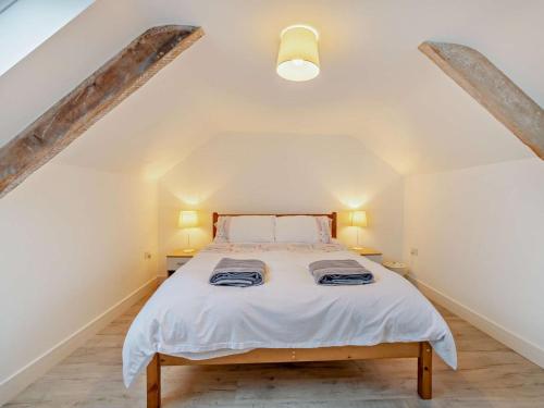 a bedroom with a bed in a attic at 4 Bed in Cardigan oc-94137 in Aberporth