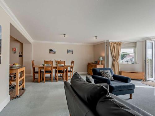 a living room with a couch and a dining room at 2 Bed in Tenby oc-fb032 in Tenby