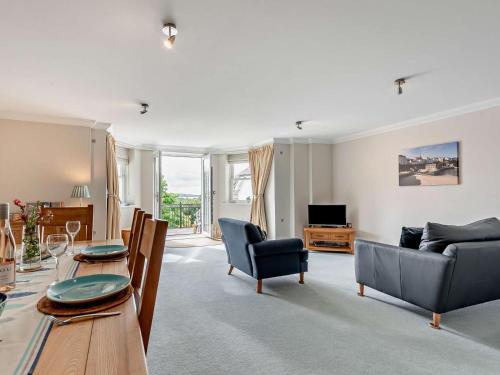 a living room with a table and a couch at 2 Bed in Tenby oc-fb032 in Tenby