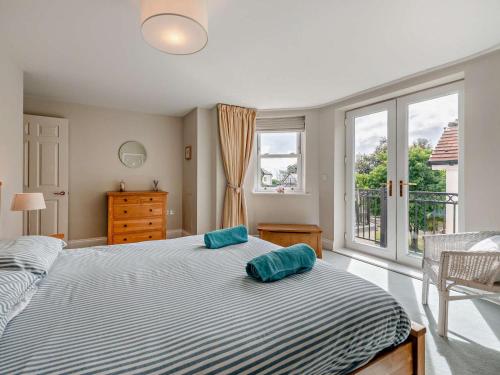 a bedroom with a bed with two pillows on it at 2 Bed in Tenby oc-fb032 in Tenby