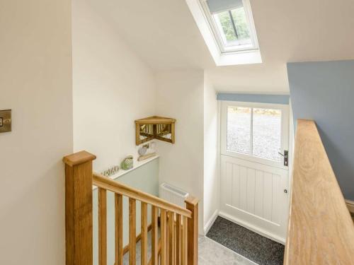 a staircase with a white door and a window at 1 Bed in Llanrwst oc-83950 in Llanrwst