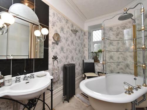a bathroom with two sinks and a tub and a shower at 1 Bed in Goodwick oc-fb158 in Goodwick