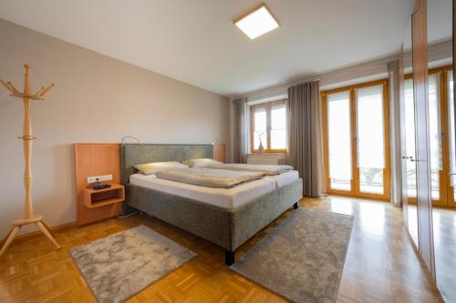 a bedroom with a bed and a cross on the wall at Ferienwohnung Lex in Bad Griesbach