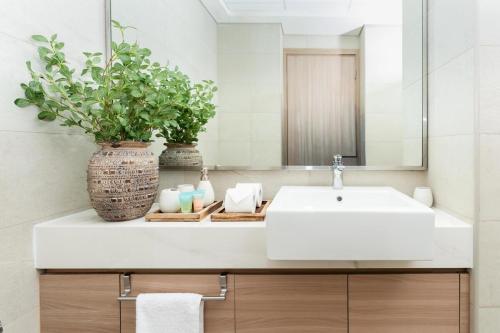 a bathroom with a white sink and a mirror at Luxurious Studio Hidden Condo In Dubai in Dubai