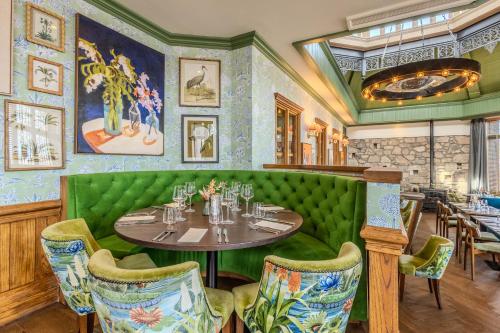 a dining room with a table and chairs at Palm Court Hotel in Aberdeen
