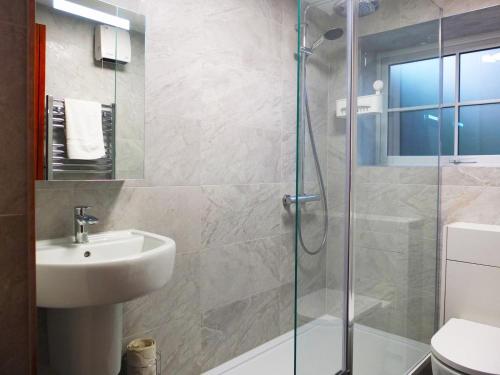a bathroom with a sink and a glass shower at 2 Bed in Colwyn Bay oc-50933 in Eglwys-Fâch