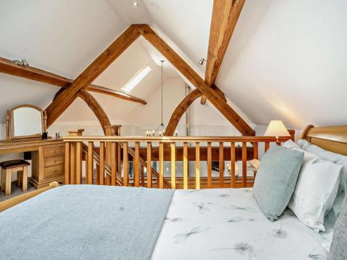 a bedroom with a bed in a room with wooden beams at 1 Bed in Narberth oc-72867 in Whitland