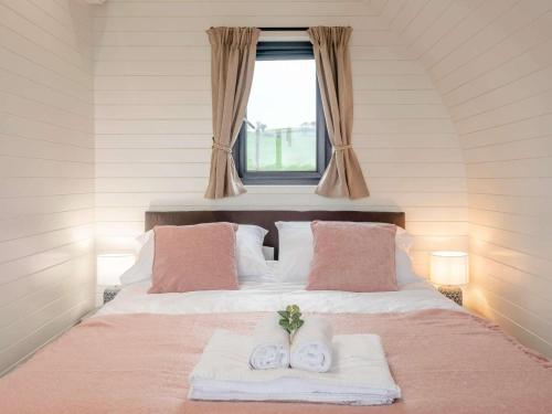 a bedroom with a bed with two towels and a window at 1 Bed in Corwen oc-80320 in Gwyddelwern