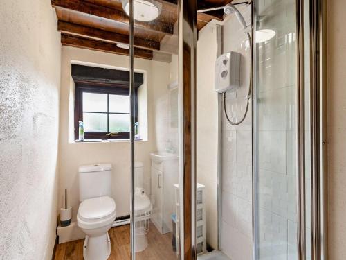a bathroom with a toilet and a glass shower at 1 Bed in Swansea oc-74221 in Ilston
