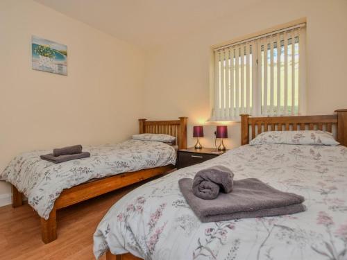 a bedroom with two beds with towels on them at 2 Bed in Bala oc-86964 in Llandderfel