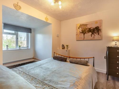 a bedroom with a large bed and a window at 2 Bed in Mold oc-90461 in Caerwys