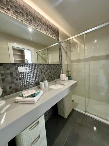 a bathroom with a sink and a shower at Apartamento Somo Playa con garaje, Cantabria in Somo