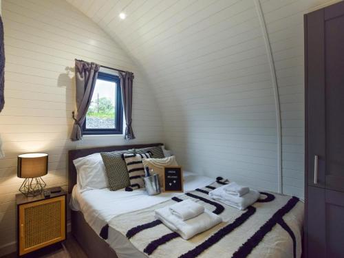 a bedroom with a bed with towels on it at 1 Bed in Corwen oc-80321 in Gwyddelwern