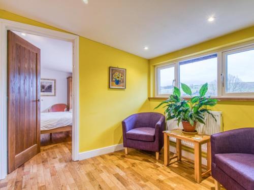 a room with yellow walls and two chairs and a bed at 4 Bed in Newtown oc-48641 in Kerry