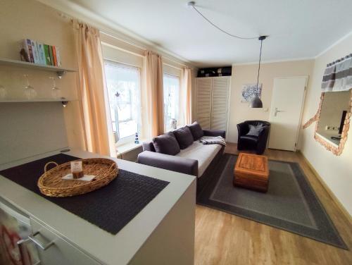 a living room with a couch and a table at Ferienwohnung Seerose mit Terrasse in Sassnitz