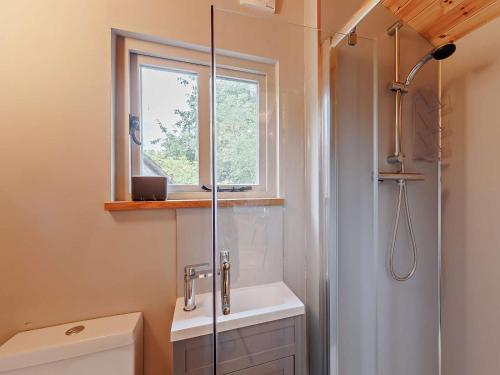 a bathroom with a shower and a toilet and a window at 1 Bed in Welshpool oc-92796 in Welshpool