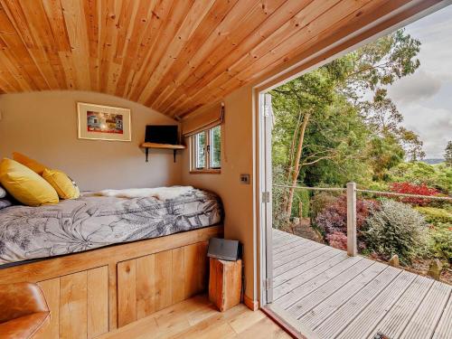 a bedroom in a tiny house with a balcony at 1 Bed in Welshpool oc-92796 in Welshpool