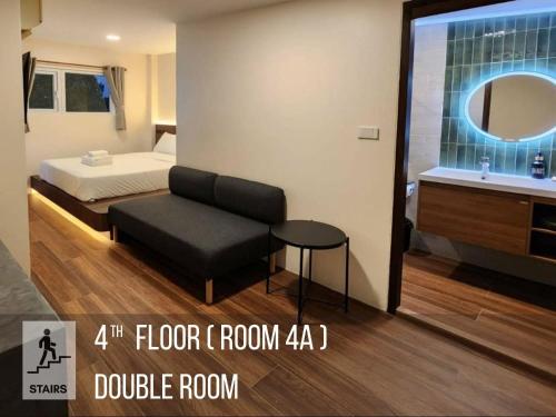 a bedroom with a bed and a couch and a table at Old City Hall, Contactless Check In in Bangkok