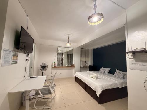 a hospital room with a bed and a desk at Paradise Beach Apartment in Boracay