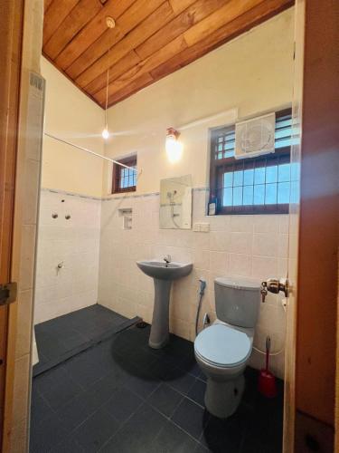 a bathroom with a toilet and a sink at Lovely Home in Panadura